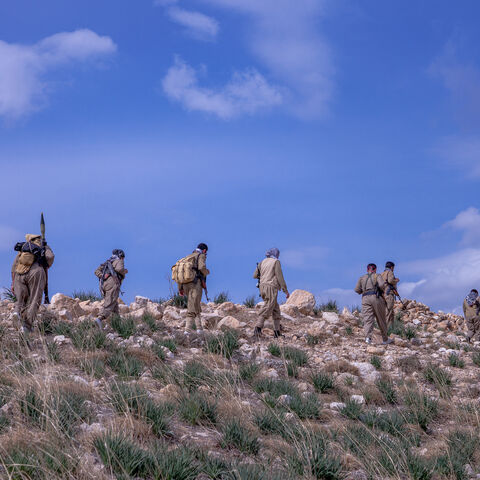A group of Peshmergas of the Democratic Party of Iranian Kurdistan (PDKI) walks during military training near one of their bases in the Kurdistan Region of Iraq, on March 1, 2025. 