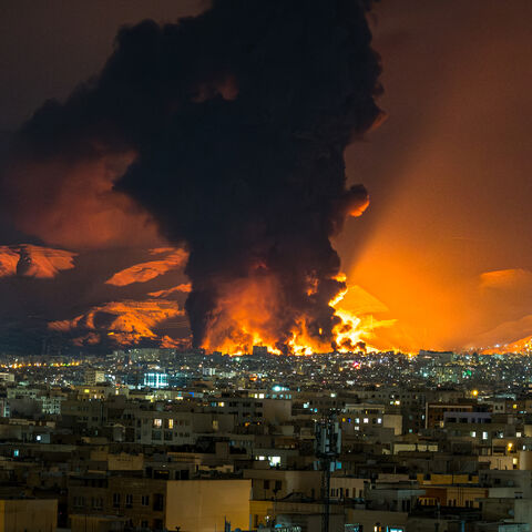 Smoke and flames rise at the site of airstrikes on an oil depot in Tehran on March 7, 2026. 