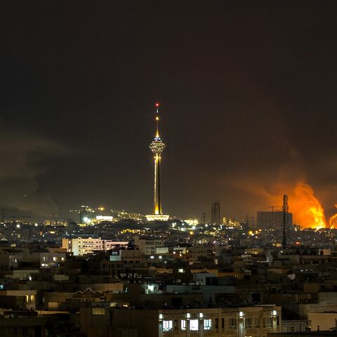Smoke and flames rise at the site of airstrikes on an oil depot in Tehran on March 7, 2026. 