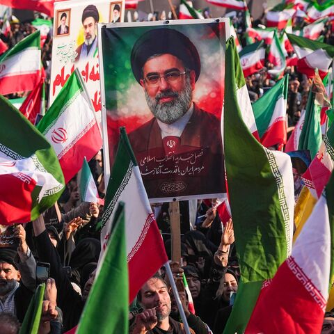 A demonstrator holds a picture of Iran's new supreme leader, Ayatollah Mojtaba Khamenei, at Enghelab Square in central Tehran on March 9, 2026.