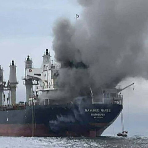This handout photo taken on March 11, 2026 and released by the Royal Thai Navy shows smoke rising from the Thai bulk carrier 'Mayuree Naree' near the Strait of Hormuz after an attack. A Thai bulk carrier travelling in the crucial Strait of Hormuz was attacked March 11, with 20 crew members rescued so far, the Thai navy said. (Photo by Handout / ROYAL THAI NAVY / AFP via Getty Images) / -----EDITORS NOTE --- RESTRICTED TO EDITORIAL USE - MANDATORY CREDIT "AFP PHOTO / ROYAL THAI NAVY " - NO MARKETING - NO ADV