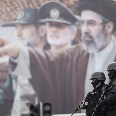  A billboard shows a graphic depicting Iranian Supreme Leader Ayatollah Mojtaba Khamenei with military commanders, as people attend the annual anti-Israeli Quds Day on March 13, 2026, in Tehran, Iran. 