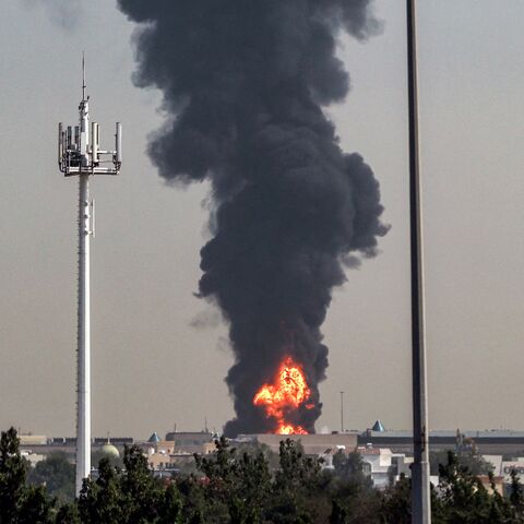 A smoke plume rises from an ongoing fire near Dubai International Airport in Dubai on March 16, 2026.