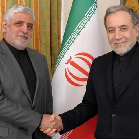 Iran’s ambassador to Beirut, Mohammad Reza Sheibani (L), shakes hands with Iranian Foreign Minister Abbas Araghchi in an undated photo. 