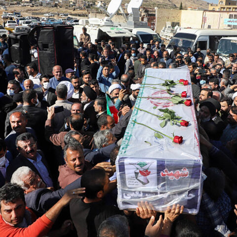 Iranians carry the coffin of one of the people killed in a shooting attack, during their funeral in the city of Izeh in Iran's Khuzestan province, on November 18, 2022. In some of the worst violence since the protests erupted, assailants on motorbikes shot dead seven people, including a woman and two children aged nine and 13, at a central market of Izeh on the evening of November 16, 2022, state media said. (Photo by ALIREZA MOHAMMADI / isna / AFP) (Photo by ALIREZA MOHAMMADI/isna/AFP via Getty Images)
