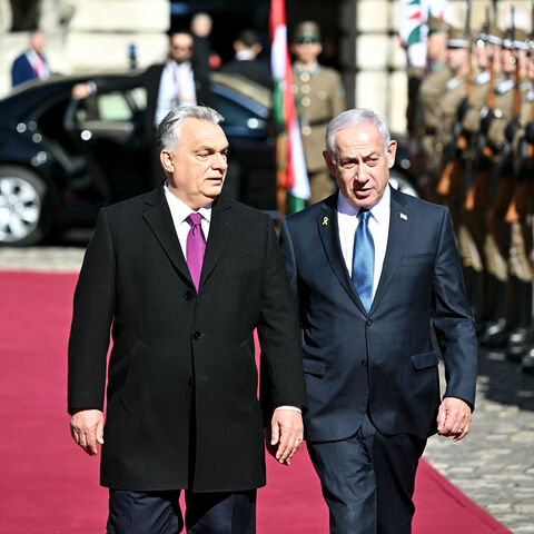 Hungary's Prime Minister Viktor Orban (L) and Israeli Prime Minister Benjamin Netanyahu review a military honor guard on April 3, 2025 in Budapest, Hungary. Israeli Prime Minister Benjamin Netanyahu arrived in Hungary in defiance of the International Criminal Court (ICC)'s arrest warrant against him over alleged war crimes in Gaza. Hungary has long-standing ties with Israel, and they been further bolstered up since the start of the war in Gaza, sparked by the Palestinian militant group Hamas's attack on Oct