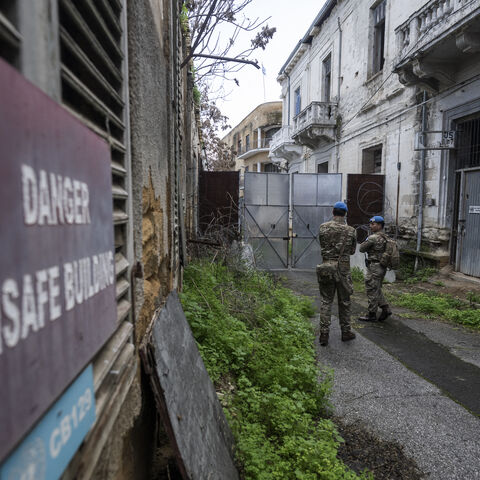 Members of the UN Peacekeeping Force in Cyprus (UNFICYP), from the British Army's 1st Battalion Coldstream Guards, No. 2 Company, patrol along the buffer zone separating the internationally recognized Republic of Cyprus and the breakaway Turkish Republic of Northern Cyprus in the divided capital Nicosia on Feb. 17, 2026. 