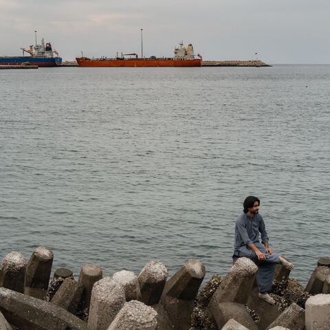People celebrate Eid and watch oil tankers sail into Muscat Anchorage on March 22, 2026, at Sultan Qaboos Port in Muscat, Oman.