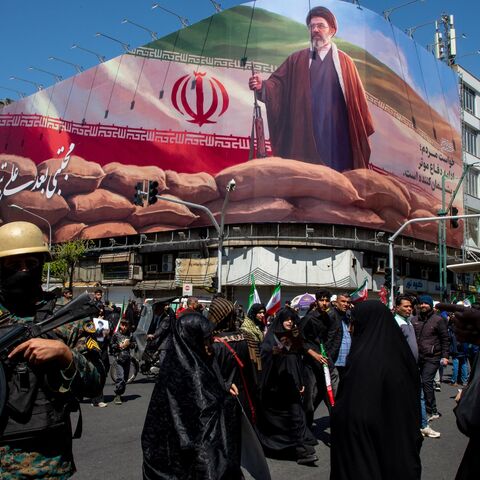 People gather under a large portrait of Iran's new Supreme Leader, Mojtaba Khamenei, during a memorial to mark the 40th day since his father, Ali Ayatollah Khamenei, was killed in US-Israeli joint strikes, on April 9, 2026, in Tehran, Iran.