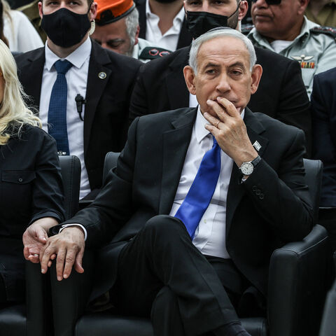 Israel's Prime Minister Benjamin Netanyahu holds the hand of his wife Sara as they attend a ceremony commemorating Israel's Remembrance Day for fallen soldiers, or Yom HaZikaron, at the Military Cemetery on Mount Herzl in Jerusalem on April 21, 2026. (Photo by Ilia YEFIMOVICH / POOL / AFP via Getty Images)