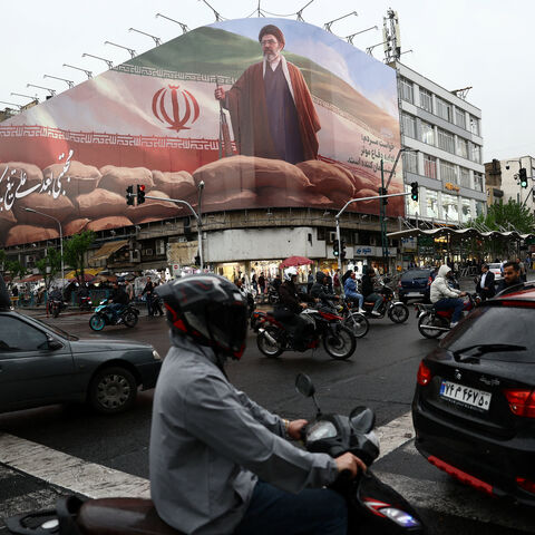 People ride motorcycles near a billboard featuring an image of Iran's new Supreme Leader Mojtaba Khamenei, amid a ceasefire between U.S. and Iran, in Tehran, Iran, April 20, 2026. Majid Asgaripour/WANA (West Asia News Agency) via REUTERS