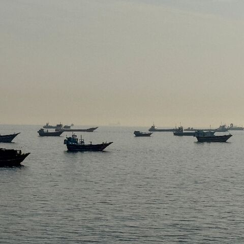Vessels are seen anchored in the Strait of Hormuz, off the port city of Khasab on Oman's northern Musandam Peninsula on May 17, 2026