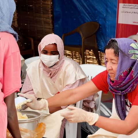 Janti Soeripto helps at a community kitchen serving hot meals to displaced families arriving from El-Fasher.