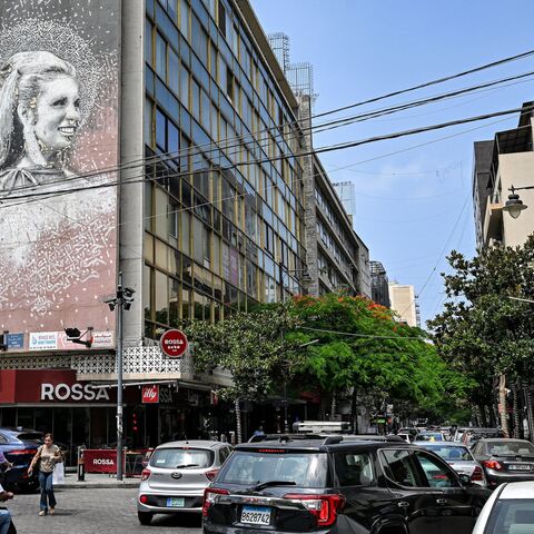 Vehicles move past a giant mural on the side of a building showing an image of the late Lebanese actress and singer Sabah (1927-2014) along Beirut's Hamra street on June 20, 2024. 