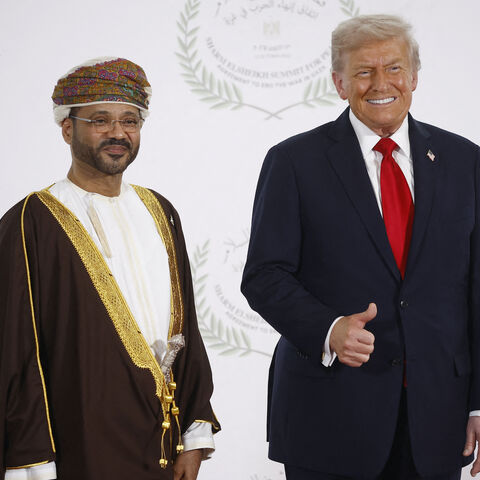 Oman's Foreign Minister Sayyid Badr Albusaidi (L) and US President Donald Trump pose during a summit on Gaza in Sharm el-Sheikh on October 13, 2025. 