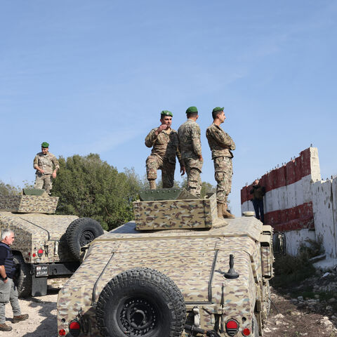 This photograph taken during a press tour organised by the Lebanese army shows Lebanese soldiers standing atop military vehicles in Alma Al-Shaab, near the border with Israel in southern Lebanon, on Nov. 28, 2025.