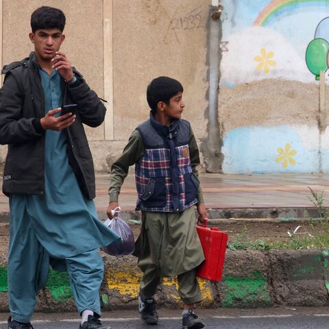 Baluch Iranian youths cross a street in Zahedan, in the southeastern province of Sistan-Baluchistan bordering Afghanistan, on Dec. 18, 2025.