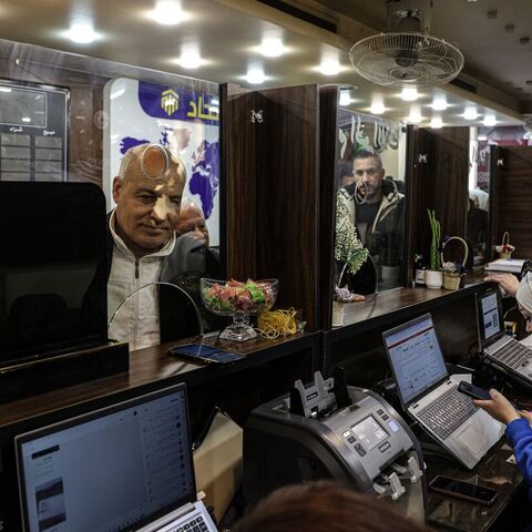 A Syrian citizen exchanges old banknotes for new notes released and distributed by the central bank, at a bank in the capital, Damascus, on Jan. 3, 2026. — Bakr ALkasem / AFP via Getty Images