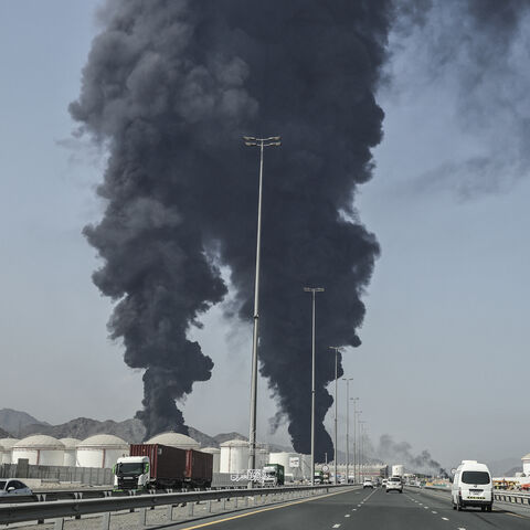 TOPSHOT - Smoke rises from the direction of an energy installation in the Gulf emirate of Fujairah on March 14, 2026. Smoke could be seen rising from the direction of a major UAE energy installation on March 14, in what appeared to be the latest strike targeting the Gulf's petroleum facilities hours after the US struck Iran's Kharg Island. (Photo by AFP via Getty Images) /
