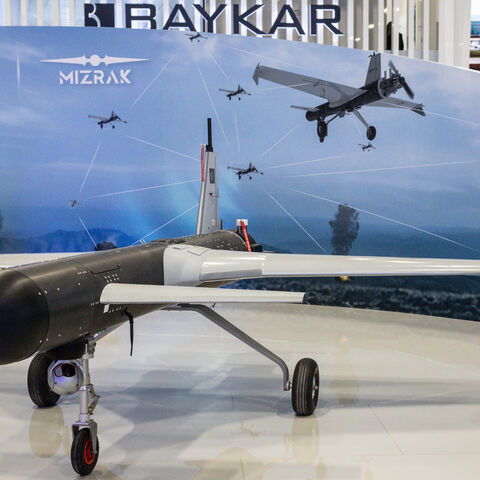 People look at a drone on display at the Baykar exhibit at the SAHA International Defence and Aerospace Expo on May 06, 2026 in Istanbul, Turkey. 