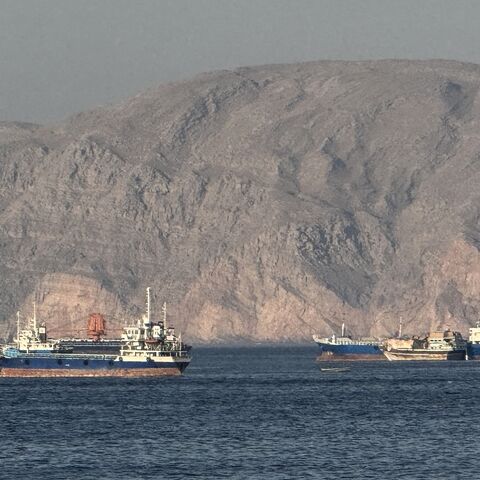 Vessels are seen anchored in the Strait of Hormuz, off the port city of Khasab on Oman's northern Musandam Peninsula on May 17, 2026. 