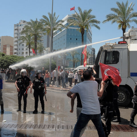Turkish riot police use water cannon to disperse protesters during a rally called by ousted opposition leader Ozgur Ozel, days after a court dismissed him from office, in Izmir on May 26, 2026. 