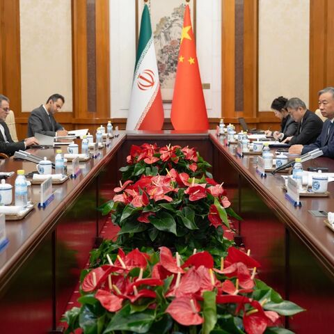  In this photo released by Xinhua News Agency, Chinese Foreign Minister Wang Yi, second right, talks to his Iranian Counterpart Abbas Araghchi, left, during the bilateral meeting in Beijing, Wednesday, May 6, 2026.