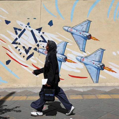 An Iranian woman walks past an anti-Israeli mural, after U.S. and Iranian officials said they had reached a deal to end their war and reopen the Strait of Hormuz, in Tehran, Iran, June 15, 2026. Majid Asgaripour/WANA (West Asia News Agency) via REUTERS