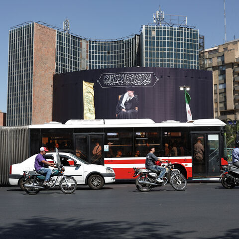 People drive past a billboard with a picture of the late Iran's Supreme Leader Ayatollah Ali Khamenei, after U.S. and Iranian officials said they had reached a deal to end their war and reopen the Strait of Hormuz, in Tehran, Iran, June 15, 2026. Majid Asgaripour/WANA (West Asia News Agency) via REUTERS