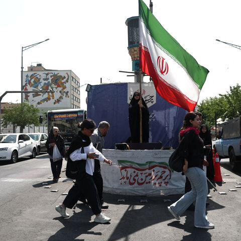 A woman holds an Iranian flag on a street in Tehran, Iran, June 10, 2026. Majid Asgaripour/WANA (West Asia News Agency) via REUTERS