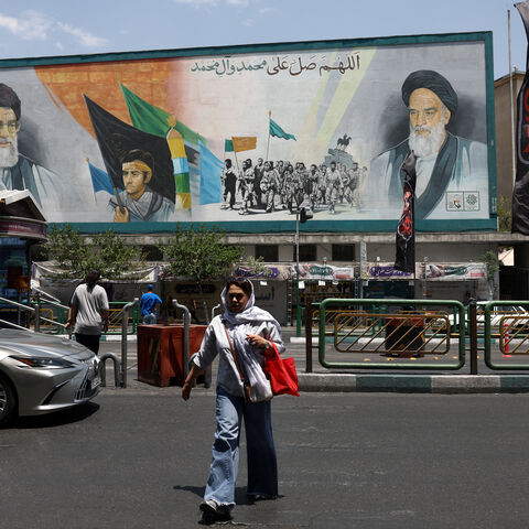 A woman walks near a mural depicting the late leader of the Islamic Revolution, Ayatollah Ruhollah Khomeini, and Iran's late Supreme Leader Ayatollah Ali Khamenei, on a street in Tehran, Iran, June 18, 2026. Majid Asgaripour/WANA (West Asia News Agency) via REUTERS