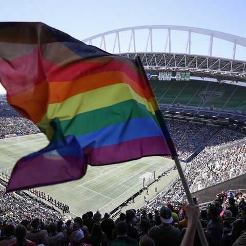 A fan waves a Pride flag before the game between the Seattle Sounders and the Portland Timbers at Lumen Field on June 3, 2023, in Seattle, Washington. 
