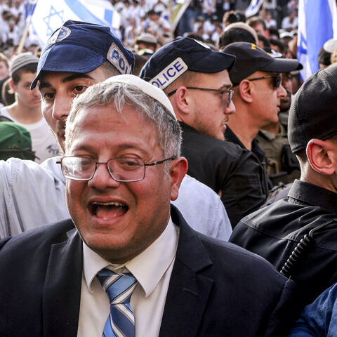 Israeli policemen surround Israeli Minister of National Security and far-right politician Itamar Ben-Gvir as he arrives outside the Damascus Gate of the walled Old City of Jerusalem on May 26, 2025, during a flag march for Jerusalem Day, commemorating the Israeli army's 1967 capture of the city's eastern sector during the Arab-Israeli war. 