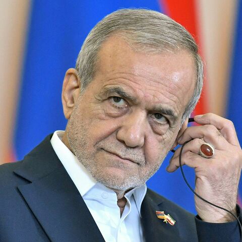 Iranian President Masoud Pezeshkian listens during a joint press conference alongside Armenia's Prime Minister in Yerevan on August 19, 2025.