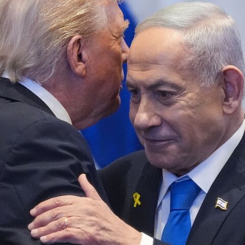 US President Donald Trump talks with Israeli Prime Minister Benjamin Netanyahu in the Knesset, Jerusalem, Oct. 13, 2025.