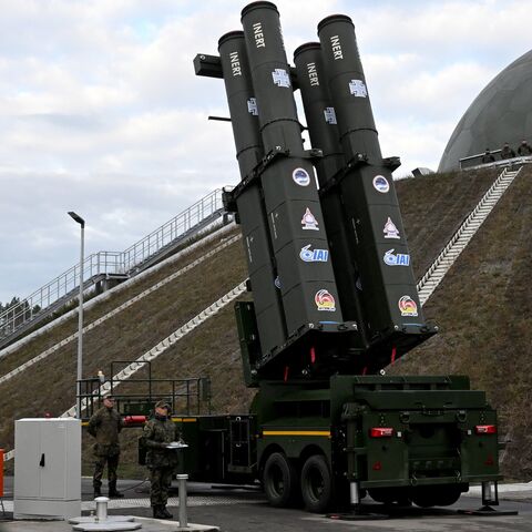 People stand in front of the Arrow 3 shield system during an event of the German Air Force to declare the Initial Operating Capability for the Arrow Weapon System for Germany at the Annaburger Heide Air Base in Schoenewalde / Holzdorf, eastern Germany, on Dec. 3, 2025.