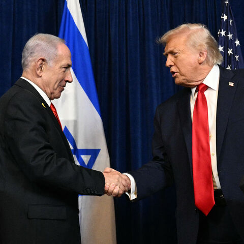 US President Donald Trump (R) and Israeli Prime Minister Benjamin Netanyahu shake hands as they arrive to speak to journalists during a joint press conference at Trump's Mar-a-Lago residence in Palm Beach, Florida, on Dec. 29, 2025.  