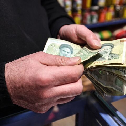 A shop owner counts Iranian banknotes at a store in the capital Tehran on Jan. 7, 2026.