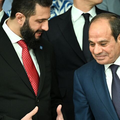 Syria's President Ahmed al-Sharaa (L) chats with Egypt's President Abdel Fattah al-Sisi as they arrive for a family photo after a working session of the European Council and regional partners as part of an informal meeting in Nicosia on April 24, 2026.