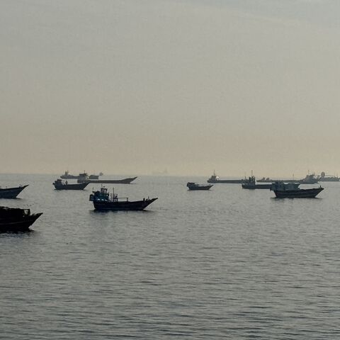 Vessels are seen anchored in the Strait of Hormuz, off the port city of Khasab on Oman's northern Musandam Peninsula, on May 17, 2026. 