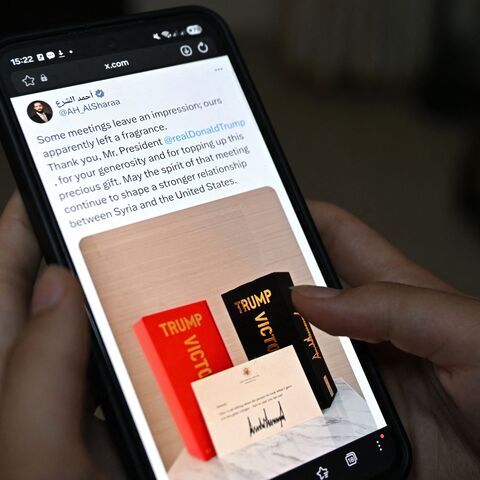 This photo illustration taken in Damascus on May 20, 2026, shows the X account of Syrian President Ahmed al-Sharaa on a smartphone displaying his tweet to President Donald Trump. 