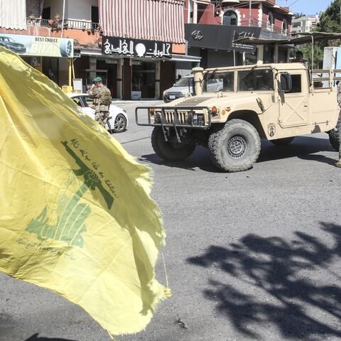 Lebanese soldiers man a check point beside a Hezbollah flag at the entrance to Nabatieh on June 15, 2026.