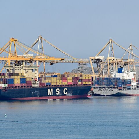 The Liberia-flagged container vessel MSC Tasman VI and the Singapore-flagged container vessel Wan Hai 353 are docked along a pier at the Khor Fakkan Container Terminal, the only natural deep-sea port in the region and one of the major container ports in Sharjah Emirate, along the Gulf of Oman on June 19, 2026. 