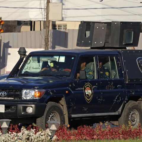 aqi security personnel patrol in a vehicle along a street in Baghdad on June 28, 2026.