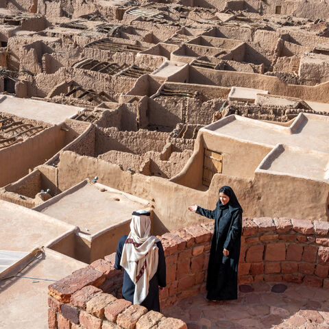 A Rawi with a visitor in AlUla’s old town, photo displayed at UNESCO’s headquarters in Paris, France. (Photo by Nick Jackson).