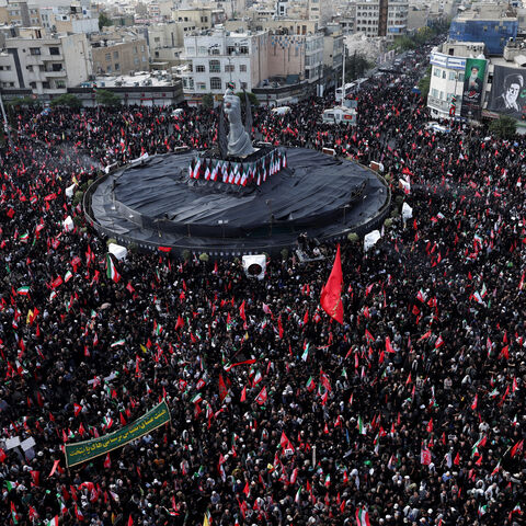 Mourners gather around a monument in the form of a raised fist of the deceased supreme leader of Iran, Ayatollah Ali Khamenei, in Enghelab Square, during a funeral procession for Khamenei, who was killed on February 28 in Israeli and U.S. airstrikes, in Tehran, Iran, July 6, 2026.  REUTERS/Murad Sezer