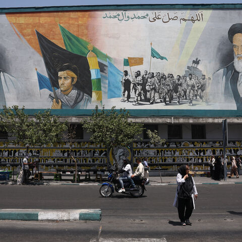 People walk past a mural depicting the late leader of the Islamic Revolution, Ayatollah Ruhollah Khomeini, and Iran's late Supreme Leader Ayatollah Ali Khamenei, on a street in Tehran, Iran, July 15, 2026. Majid Asgaripour/WANA (West Asia News Agency) via REUTERS