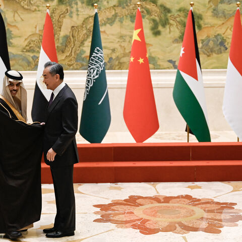 China's Foreign Minister Wang Yi (R) shakes hands with Saudi Arabia's Foreign Minister Prince Faisal bin Farhan Al-Saud before a family photo for the attendees of a meeting of foreign ministers from Arab and Muslim-majority nations at the Diaoyutai State Guest House in Beijing on November 20, 2023. The international community must take urgent action to stop the "humanitarian disaster" unfolding in Gaza, Chinese Foreign Minister Wang Yi told visiting diplomats from Arab and Muslim-majority nations on Novembe