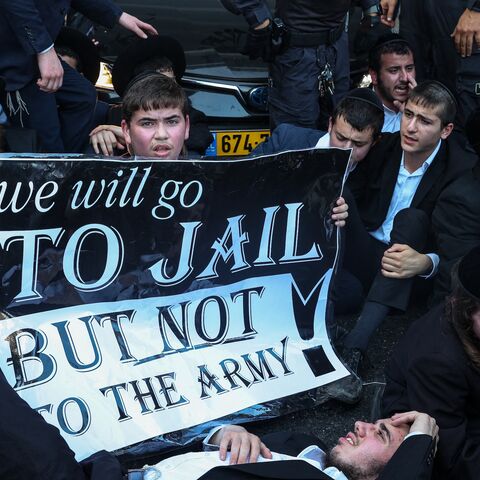 Israeli police officers clash with ultra-Orthodox Jewish men during a protest against their conscription, Bnei Brak, Israel, July 16, 2024.