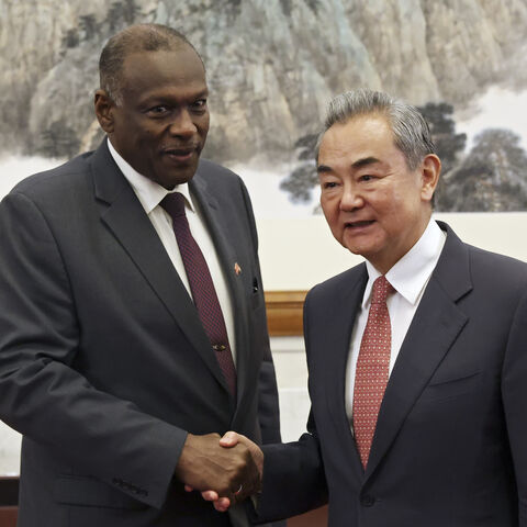 BEIJING, CHINA - MAY 14: Chinese Foreign Minister Wang Yi (R) shake hands with Omar Seddik, Sudan's newly appointed foreign minister before their meeting during the China-CELAC Forum at Diaoyutai State Guest House on May 14, 2025 in Beijing, China. The summit includes China's key Latin American trade partners, and comes as Beijing and Washington work on defusing a trade war. (Photo by Florence Lo - Pool/Getty Images)